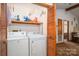 Functional laundry area with full washer and dryer set, with a view into an adjacent sitting room at 8749 Dog Leg Rd # 7, Sherrills Ford, NC 28673