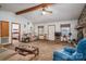 Cozy living room features a stone fireplace, beamed ceilings, and carpeted floors at 8749 Dog Leg Rd # 7, Sherrills Ford, NC 28673