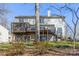 Exterior of home featuring a multi-level deck, stairs, and a lush green lawn at 8802 Glenside St, Huntersville, NC 28078