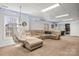 Relaxing basement featuring a sectional sofa, hammock chair, and ample space at 8802 Glenside St, Huntersville, NC 28078