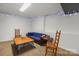 Inviting basement area with cozy seating, wooden table, and decorative string lights at 8802 Glenside St, Huntersville, NC 28078