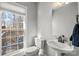 Bright bathroom features classic fixtures, ample light, and a view of the back deck at 8802 Glenside St, Huntersville, NC 28078