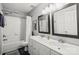 Well-lit bathroom featuring a double sink vanity and a shower-tub combination at 8802 Glenside St, Huntersville, NC 28078