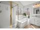 Bright bathroom with a shower, soaking tub, dual windows, and a vanity with a sink at 8802 Glenside St, Huntersville, NC 28078