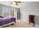 Bright bedroom with large windows and neutral tones, ceiling fan, and ample storage space at 8802 Glenside St, Huntersville, NC 28078