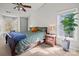 Bright bedroom features a large window, ceiling fan, and a comfortable bed with decorative pillows at 8802 Glenside St, Huntersville, NC 28078