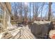 Spacious wooden deck with a grill and seating offers a great spot for outdoor dining and relaxation at 8802 Glenside St, Huntersville, NC 28078