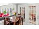 Inviting dining area with a wooden table, surrounded by windows with natural light and views of outdoor scenery at 8802 Glenside St, Huntersville, NC 28078