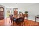 Elegant dining room with hardwood floors, a chandelier, and ample natural light for gatherings at 8802 Glenside St, Huntersville, NC 28078