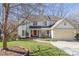 Charming two-story home with well-manicured lawn, mature trees, and a bright red front door at 8802 Glenside St, Huntersville, NC 28078
