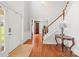 Bright foyer with hardwood floors, a staircase, and classic décor creates an inviting entrance at 8802 Glenside St, Huntersville, NC 28078