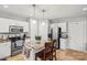 Well-lit kitchen with stainless steel appliances, granite countertops, and a central island with barstool seating at 8802 Glenside St, Huntersville, NC 28078