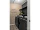 Efficient laundry room with modern washer and dryer, shelving, and stylish tile flooring at 8802 Glenside St, Huntersville, NC 28078