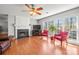 Cozy living room with a fireplace, hardwood floors, and large windows for natural light at 8802 Glenside St, Huntersville, NC 28078