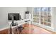 Bright home office space with large windows, hardwood floors and a modern desk setup at 8802 Glenside St, Huntersville, NC 28078