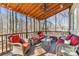 Cozy screened porch features comfortable seating, a ceiling fan, and serene views of the surrounding trees at 8802 Glenside St, Huntersville, NC 28078