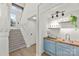 Stylish bar area featuring butcher block countertop, blue cabinets, and updated fixtures at 8932 St Croix Ln, Charlotte, NC 28277