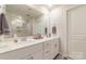 Modern bathroom featuring double vanity sinks, a large mirror, and sleek white cabinetry at 920 Clementine Rd, Monroe, NC 28110