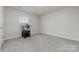 Neutral bedroom with carpet, a window, and a bedside table with decor at 920 Clementine Rd, Monroe, NC 28110