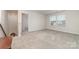 Spacious bonus room with neutral carpet, bright windows, and open doorway leading to staircase at 920 Clementine Rd, Monroe, NC 28110