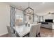 Bright dining area features a modern chandelier and stylish decor leading into the living room at 920 Clementine Rd, Monroe, NC 28110