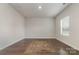 Bright, empty room featuring hardwood floors, natural light from a window, and a neutral color palette for personalization at 920 Clementine Rd, Monroe, NC 28110