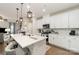 Bright, open kitchen with stainless steel appliances, white cabinets, and a spacious island with bar seating at 920 Clementine Rd, Monroe, NC 28110