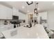 Modern kitchen featuring white cabinets, stainless steel appliances, and a large center island with quartz countertops at 920 Clementine Rd, Monroe, NC 28110