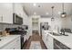 Well-lit kitchen with stainless steel appliances, ample counter space, and stylish backsplash at 920 Clementine Rd, Monroe, NC 28110