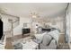 Spacious living room featuring hardwood floors, a comfortable gray sectional, and an open view to the modern kitchen at 920 Clementine Rd, Monroe, NC 28110