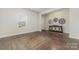 Bright, empty room offering hardwood floors, ample natural light from a window, and versatile space for customization at 920 Clementine Rd, Monroe, NC 28110