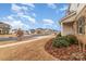 View of a street lined with houses and landscaping in a residential community at 920 Clementine Rd, Monroe, NC 28110