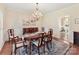 Formal dining room featuring a chandelier, wainscoting, and hardwood floors at 11309 Brittany Oaks Dr, Charlotte, NC 28277