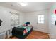 Cozy bedroom featuring wood floors, a comfortable bed, and a bright window for natural light at 12016 Antebellum Dr, Charlotte, NC 28273