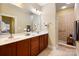 Spacious bathroom featuring a double vanity, a large mirror, and a tiled walk-in shower at 1209 Waypoint Ct, Matthews, NC 28104