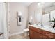 Neutral bathroom featuring tiled floors, modern vanity, and a shower with a curtain at 1209 Waypoint Ct, Matthews, NC 28104