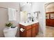 Well-lit bathroom featuring a vanity with wood cabinets and a decorative mirror at 1209 Waypoint Ct, Matthews, NC 28104