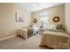 Twin bedroom featuring two beds, decorative mirrors, and neutral decor providing a cozy atmosphere at 1209 Waypoint Ct, Matthews, NC 28104