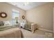 Bright bedroom features twin beds, neutral decor, and a window for natural light at 1209 Waypoint Ct, Matthews, NC 28104