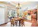 Inviting dining area features an elegant chandelier and a seamless transition to the outdoor patio at 1209 Waypoint Ct, Matthews, NC 28104