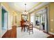 Formal dining room with wood flooring, chandelier, and access to an outdoor seating area at 1209 Waypoint Ct, Matthews, NC 28104