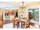 Elegant dining area featuring hardwood floors and an open floor plan, connecting seamlessly to the kitchen at 1209 Waypoint Ct, Matthews, NC 28104
