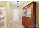 Welcoming entryway features hardwood flooring, neutral paint, a storage cabinet, and access to the bedroom at 1209 Waypoint Ct, Matthews, NC 28104