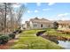 Charming single-story home with well-maintained landscaping and water feature at 1209 Waypoint Ct, Matthews, NC 28104