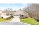 Landscaped front yard with a well maintained lawn and decorative shrubs, in front of a stone and siding single-Gathering home at 1209 Waypoint Ct, Matthews, NC 28104