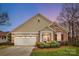 Charming single-Gathering home featuring a stone and siding exterior with a well-manicured front yard at 1209 Waypoint Ct, Matthews, NC 28104