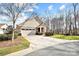 Charming single-Gathering home featuring stone accents, two-car garage, and mature trees at 1209 Waypoint Ct, Matthews, NC 28104