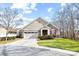 Beautiful single-Gathering home featuring stone accents, two-car garage, and mature trees at 1209 Waypoint Ct, Matthews, NC 28104