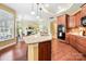 Open floor plan kitchen featuring granite countertops, wooden cabinets, and an easy transition to the living area at 1209 Waypoint Ct, Matthews, NC 28104