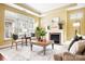 Comfortable living room featuring a fireplace, large windows, and stylish furniture arrangement, offering a cozy atmosphere at 1209 Waypoint Ct, Matthews, NC 28104
